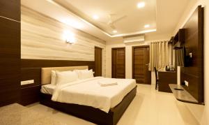 a bedroom with a large bed in a room at Nectar Nest in Coimbatore