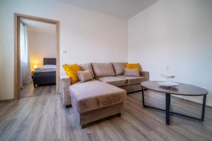 uma sala de estar com um sofá e uma mesa em Promenada Lipno Apartment 123 em Lipno nad Vltavou