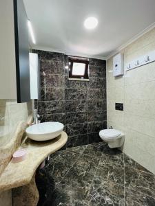 a bathroom with a sink and a toilet at Mandalina Apartments in Agva