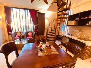 a kitchen and dining room with a wooden table and chairs at Villa Kinandari Bukit Jimbaran in Jimbaran