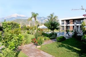 a view of a garden with mountains in the background at Mandalina Apartments in Agva