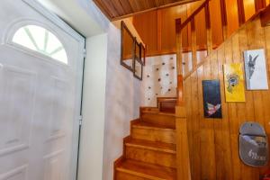 a staircase in a house with a white door at A Casa da Rapariga de Cabelo Azul in Manteigas
