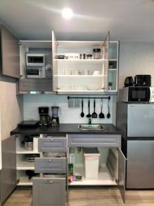 a kitchen with white cabinets and a counter top at 2 Bedroom Apartment in Naiyang - The Title Residences, Naiyang in Nai Yang Beach