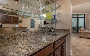 a kitchen with a granite counter top and a sink at The Oasis 2214 formerly Phoenix West II 2214 in Orange Beach