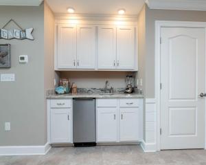 a kitchen with white cabinets and a sink at Phoenix Orange Beach II 1104 in Orange Beach