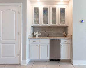 a kitchen with white cabinets and a sink at Phoenix Orange Beach II 1702 condo in Orange Beach
