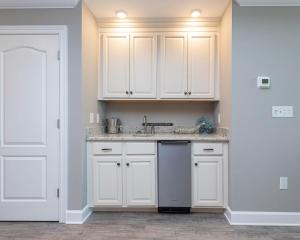 a kitchen with white cabinets and a sink at Phoenix Orange Beach II 1202 condo in Orange Beach