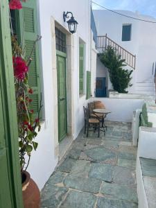 a courtyard in a house with a table and chairs at Matsas Mansions in Chora Folegandros