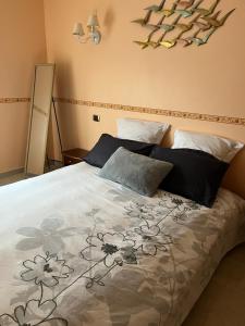 a bedroom with a bedspread with flowers on it at Côt’et Calme in Saint Malo