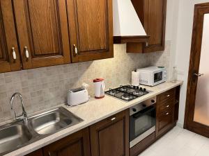 a kitchen with a sink and a stove top oven at Appartamento Michele in Greve in Chianti
