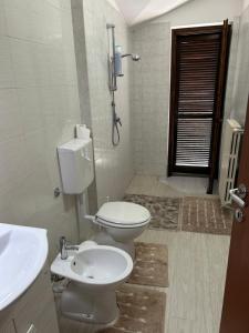 a bathroom with a toilet and a sink at B&B Caselle in Caselle Torinese