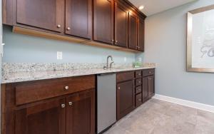 a kitchen with wooden cabinets and a sink at Phoenix Orange Beach II 1103 condo in Orange Beach