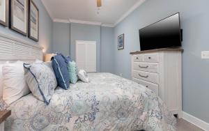 a bedroom with a bed and a flat screen tv at Phoenix Orange Beach II 1103 condo in Orange Beach +33 photos