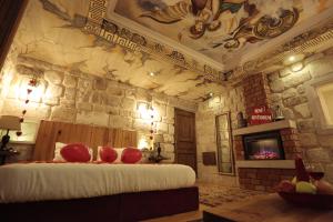 a room with a bed and a stone wall at Corner İn Cappadocia in Ortahisar