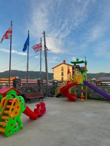 a playground with a slide and a slideintend at Snow King Hotel in Bakuriani