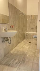 a bathroom with a sink and a toilet at Amedi Villas Tinos in Pánormos