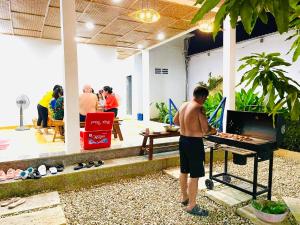 a man standing in front of a grill at HOA Homestay Phu Quoc in Phu Quoc