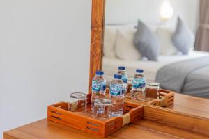 a tray of water bottles on a table in front of a mirror at Prama Beach Canggu by The Loka in Canggu