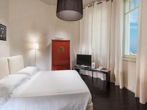 Кровать или кровати в номере Hotel Carducci 76