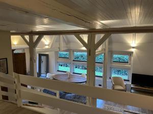 a living room with a table and some windows at Ferienwohnung St. Dionyser Heidedorf EG7 in Sankt Dionys