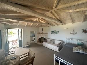 a living room with a table and a fireplace at Maroudio's Villa in Livadáki