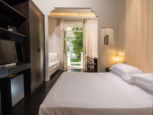 Кровать или кровати в номере Hotel Carducci 76