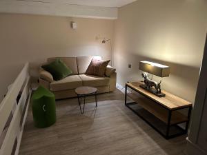 a living room with a couch and a table at Ferienwohnung St. Dionyser Heidedorf EG7 in Sankt Dionys