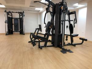 a gym with several tread machines in a room at Sweet studio in Dubai Sports City in Dubai