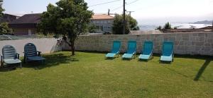 a group of chairs sitting in the grass at Vista a las Cíes in Moaña