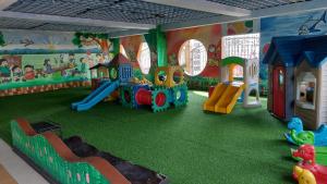 a childrens play room with a playground with a slide at Hospital ng Manila front delux le mirage de malate in Manila