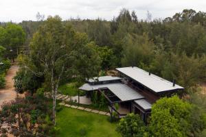 an aerial view of a house in the woods at StayVista at Cargo Haus The Luxury Collection in Bangalore