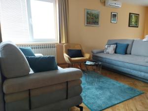 a living room with two couches and a couch at Apartman Kovač-Bilje in Bilje