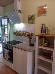 a kitchen with a stove and a counter top at Das kleine Haus in Hornburg