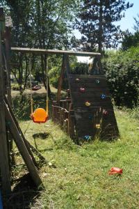 a playground with a slide in the grass at Das kleine Haus in Hornburg +33 photos