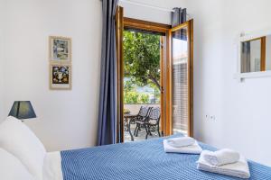 a bedroom with a bed with two towels on it at Lemon Casa in Skopelos Town