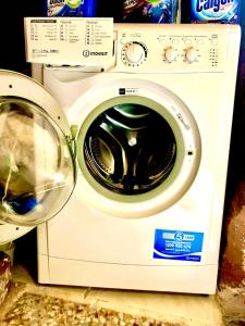 a white washer and dryer sitting on a counter at Antiche Mura Apartments"Cielo di Puglia" -2 matrimoniali, cucina e terrazzo in Turi +43 photos