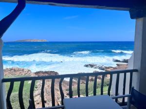 a view of the ocean from a balcony at Apartamentos El Bergantin Menorca Club in Fornells