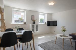 a living room with a dining room table and chairs at Newly renovated 1-Bed Apartment in Aalborg in Aalborg