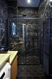 a bathroom with a shower with a sign on the wall at Neo Luxury Suite in Athens