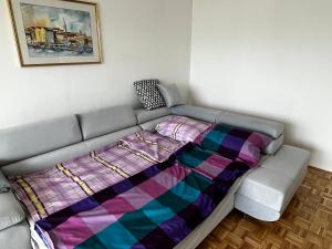 a bed with a blanket on top of it in a room at Apartment 7 in Izola