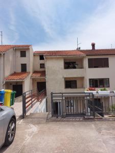 a apartment building with a car parked in front of it at Apartment Karlo, Pula in Pula