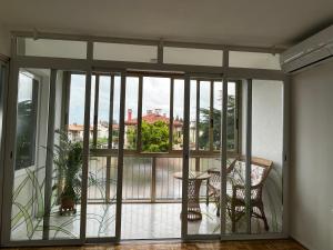a room with a balcony with a view of the city at Apartment 7 in Izola