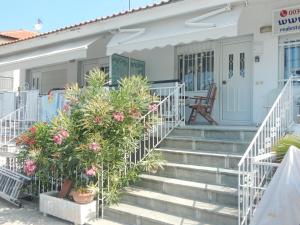 a house with stairs and flowers in front of it at Flamingo in Hanioti