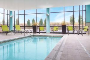 a pool with chairs and tables in a building at SpringHill Suites by Marriott Philadelphia West Chester/Exton in Exton