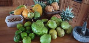 a table topped with lots of different types of fruits at Nabuco Estate Bure Rentals in Naweni