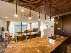 a kitchen and living room with a sink and a table at Song Cat Villa 59NL in Danang