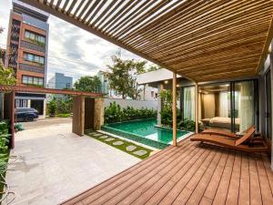 a wooden deck with a swimming pool in a house at Song Cat Villa 59NL in Danang +16 photos