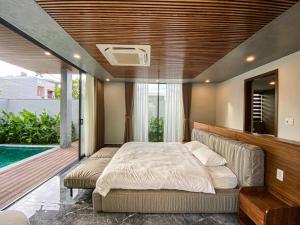 a bedroom with two beds and a swimming pool at Song Cat Villa 59NL in Danang