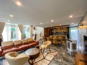 a living room with a couch and a dining room at Song Cat Villa 59NL in Danang