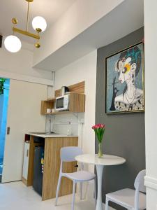 a kitchen with a table and two stools and a table at Cozy chic Silom townhouse studio 2-4 in Bangkok